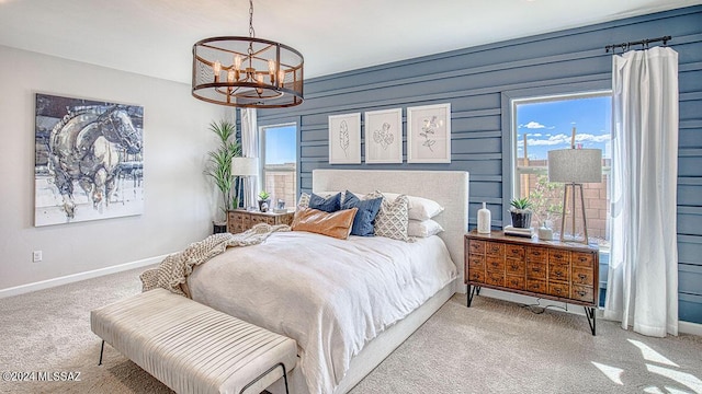 bedroom featuring carpet floors, baseboards, multiple windows, and a chandelier