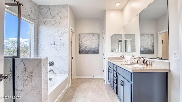bathroom featuring double vanity, a sink, baseboards, and a bath