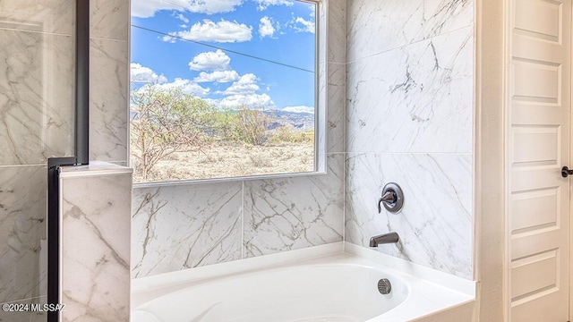 bathroom with a tub to relax in