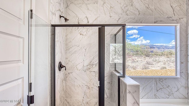 bathroom featuring a tub to relax in and a shower stall
