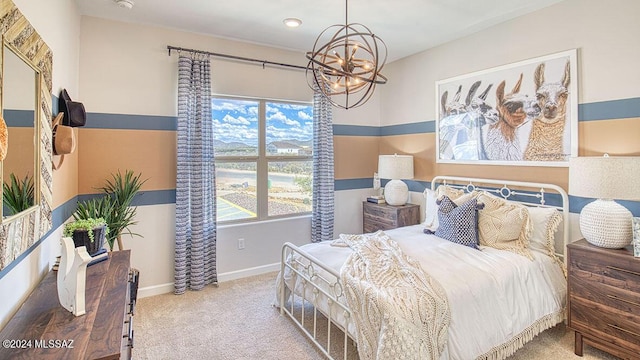 bedroom with carpet, baseboards, and a chandelier