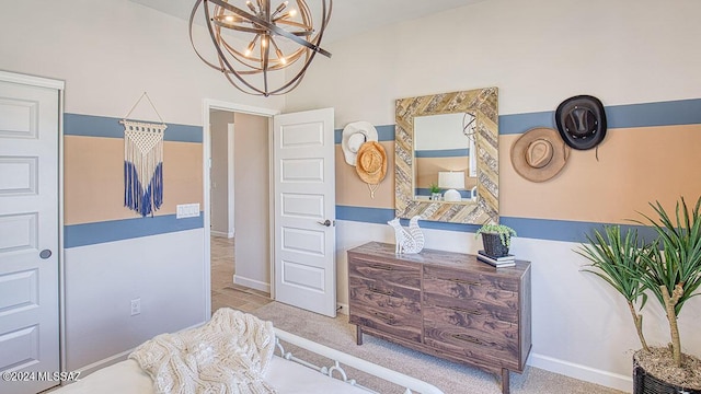 bedroom with a notable chandelier, carpet, and baseboards