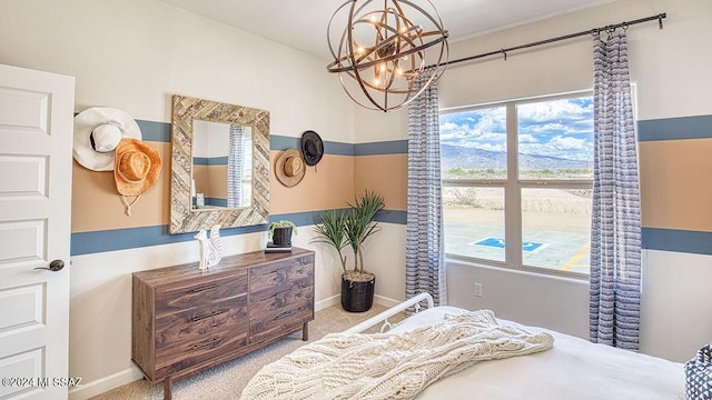 carpeted bedroom with baseboards and a notable chandelier