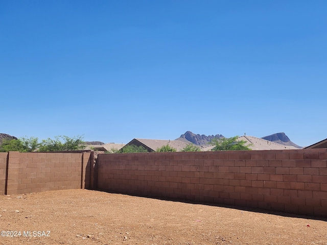 view of yard with a mountain view and a fenced backyard