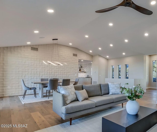 6800 N Cocopas Rd, Tucson, AZ 85718 - living room featuring lofted ceiling, wood finished floors, a ceiling fan, recessed lighting, and a chandelier