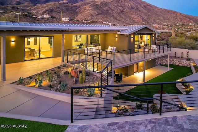 6800 N Cocopas Rd, Tucson, AZ 85718 - rear view of property with a mountain view, stucco siding, a patio, and metal roof