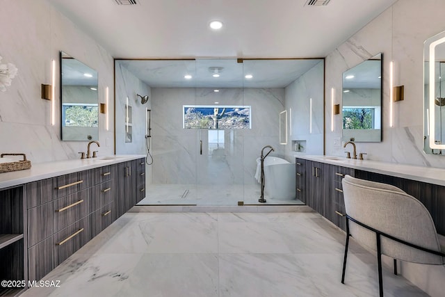 6800 N Cocopas Rd, Tucson, AZ 85718 - full bathroom with marble finish floors, a shower stall, a freestanding tub, two vanities, and recessed lighting