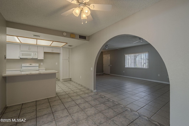 kitchen featuring white cabinets, visible vents, white appliances, ceiling fan, and arched walkways