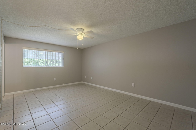 spare room with baseboards, a textured ceiling, and a ceiling fan