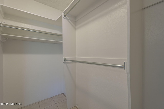 spacious closet featuring light tile patterned flooring