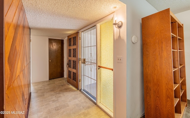 hallway with a textured ceiling