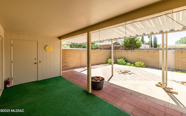view of patio featuring fence