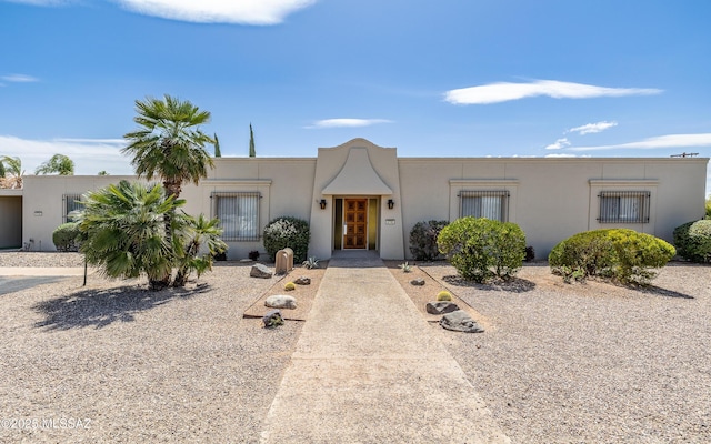 pueblo-style home with stucco siding