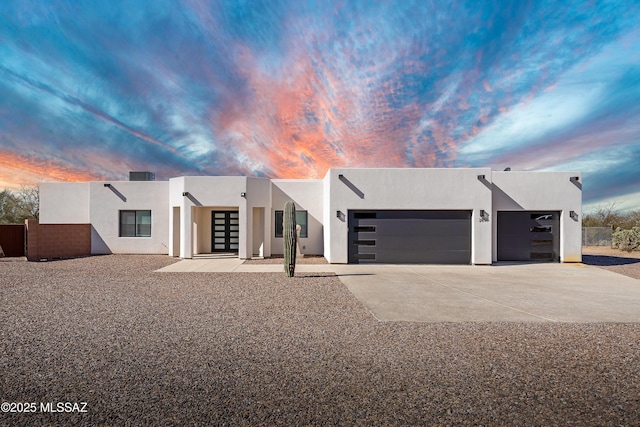 2891 N Wentworth Rd, Tucson, AZ 85749 - modern home featuring a garage, concrete driveway, and stucco siding