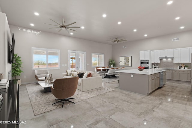 2891 N Wentworth Rd, Tucson, AZ 85749 - kitchen featuring open floor plan, light countertops, visible vents, a ceiling fan, and a kitchen island with sink