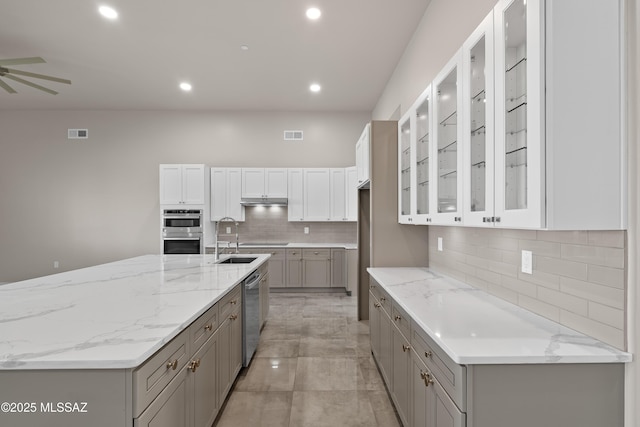 2891 N Wentworth Rd, Tucson, AZ 85749 - kitchen with backsplash, a ceiling fan, appliances with stainless steel finishes, gray cabinetry, and visible vents