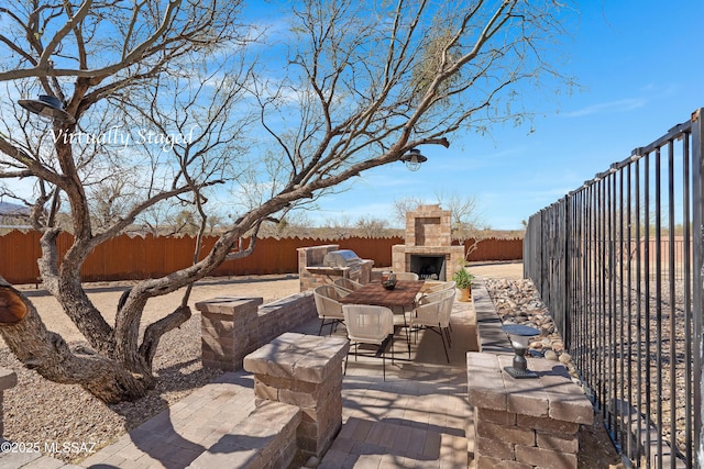2891 N Wentworth Rd, Tucson, AZ 85749 - view of patio with a fenced backyard, an outdoor stone fireplace, and outdoor dining space