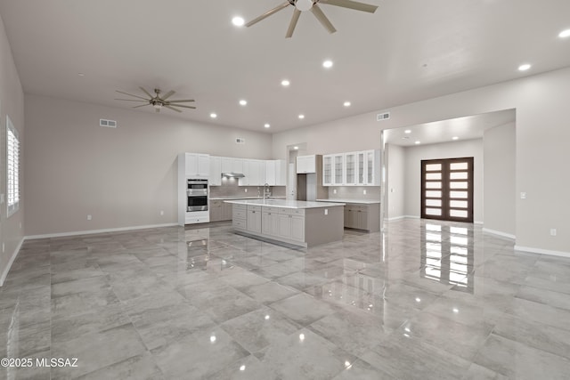 2891 N Wentworth Rd, Tucson, AZ 85749 - kitchen with visible vents, a large island with sink, a ceiling fan, and open floor plan
