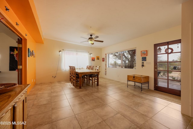 dining area featuring ceiling fan and light tile patterned floors