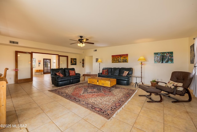 living room with visible vents, ceiling fan, and light tile patterned floors