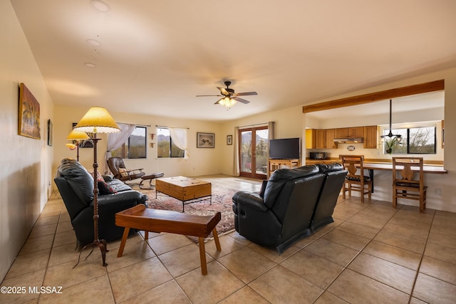 living area featuring light tile patterned floors and a ceiling fan