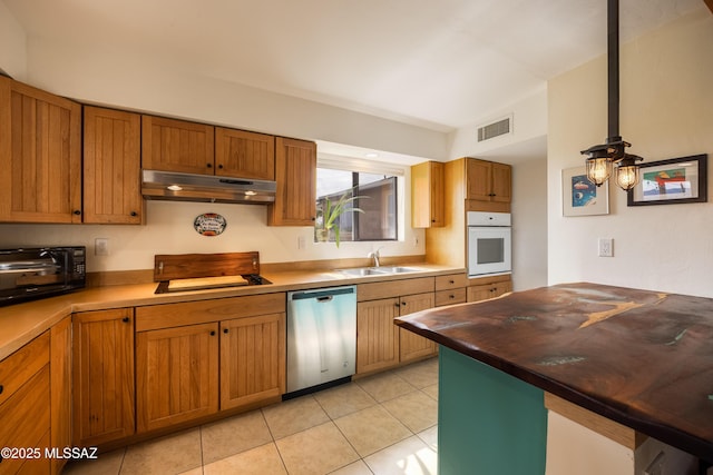 kitchen featuring white oven, visible vents, dishwasher, a sink, and under cabinet range hood