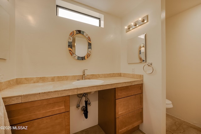 bathroom featuring toilet and vanity