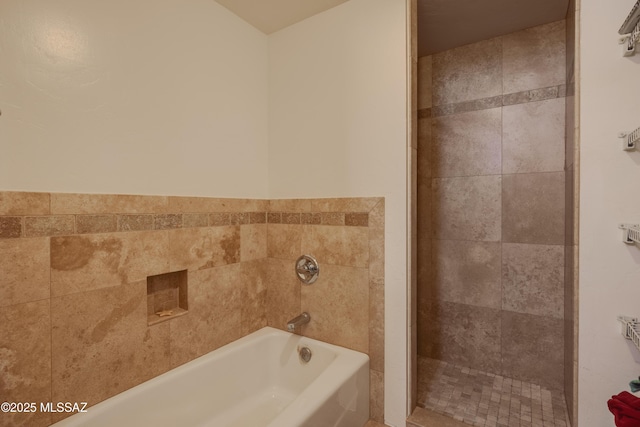 full bathroom with a garden tub and tiled shower