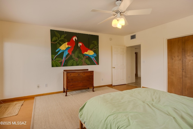 carpeted bedroom featuring baseboards, a ceiling fan, and visible vents