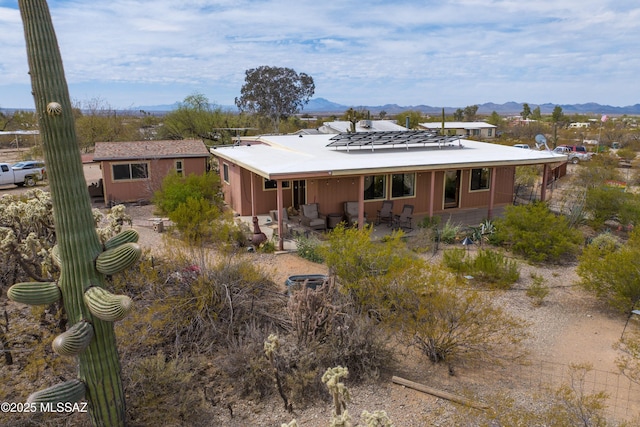 back of property featuring a patio and a mountain view