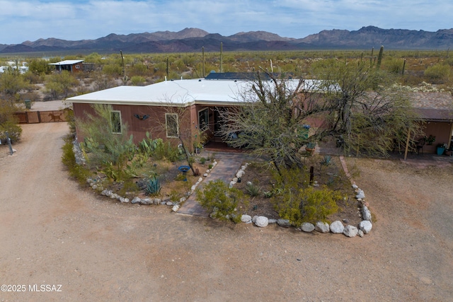 view of front of home featuring a mountain view and dirt driveway
