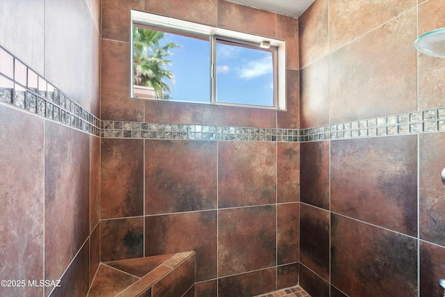 interior details featuring a tile shower