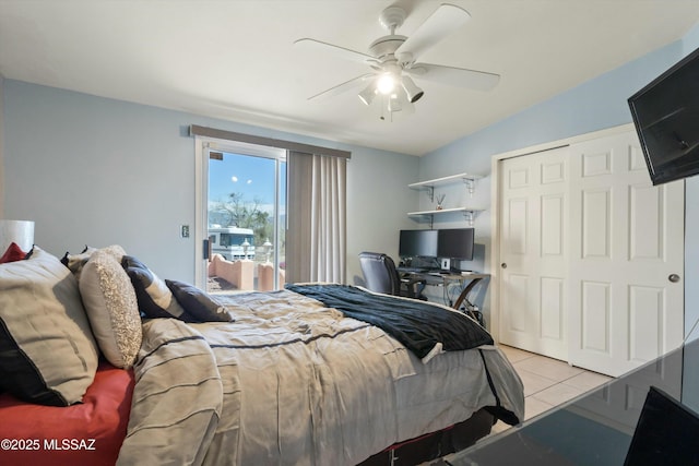 bedroom featuring a ceiling fan, light tile patterned floors, a closet, and access to exterior