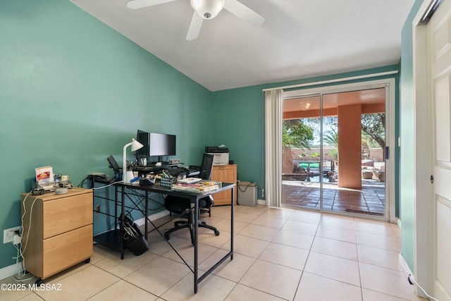 office area featuring a ceiling fan, light tile patterned floors, baseboards, and vaulted ceiling