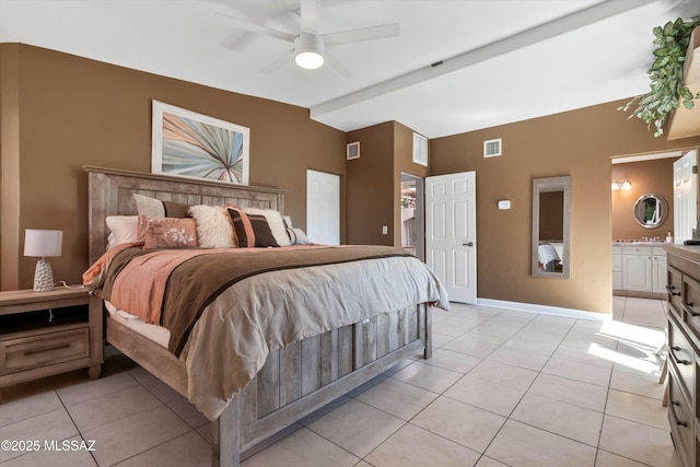 bedroom featuring baseboards, ensuite bath, visible vents, and light tile patterned floors