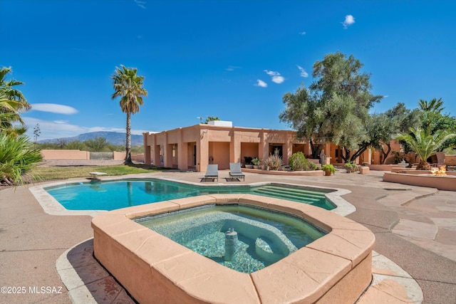 outdoor pool with an in ground hot tub, a patio area, and a diving board