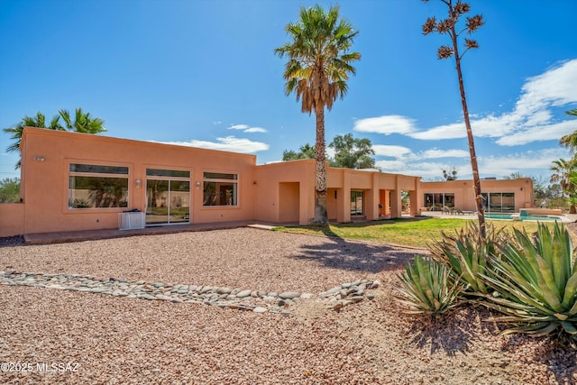 back of property featuring stucco siding and a patio area
