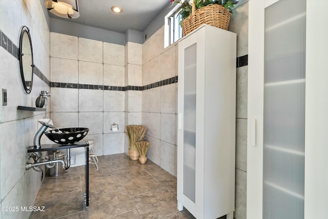 bathroom with tile walls