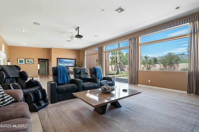 living area featuring light tile patterned floors, baseboards, visible vents, ceiling fan, and recessed lighting