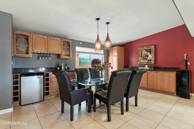 dining room with wet bar and light tile patterned flooring