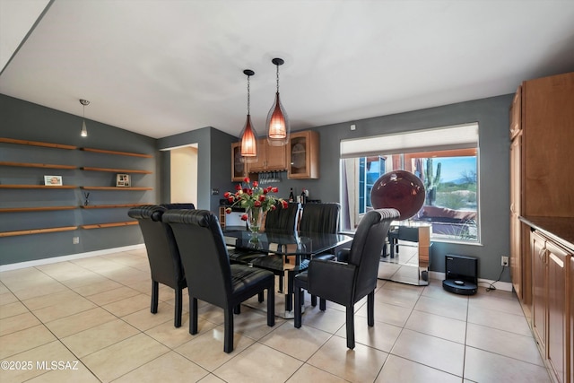 dining area with baseboards and light tile patterned floors