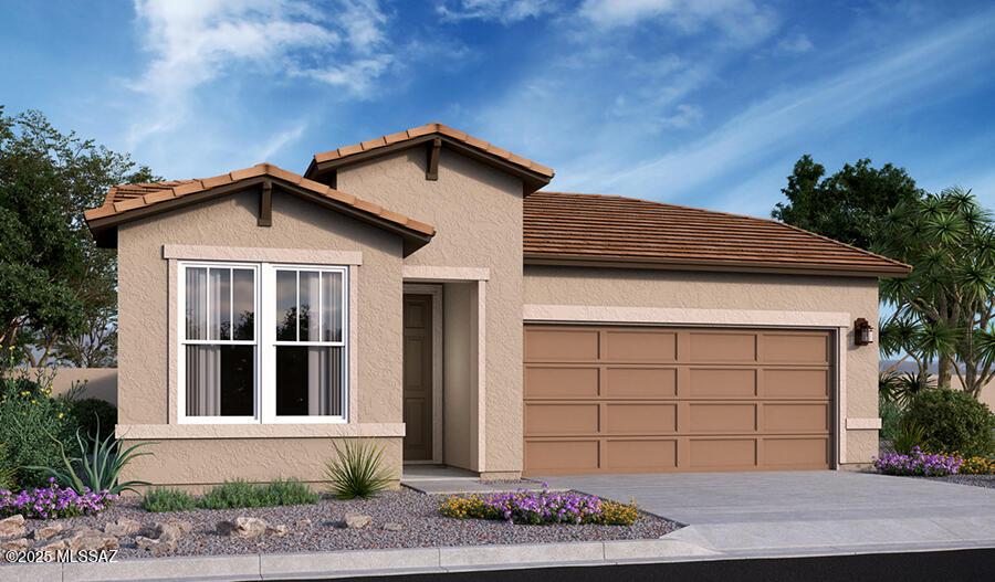 view of front facade with a tile roof, concrete driveway, stucco siding, and an attached garage