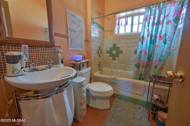 bathroom featuring shower / bath combination with curtain, toilet, decorative backsplash, and a sink