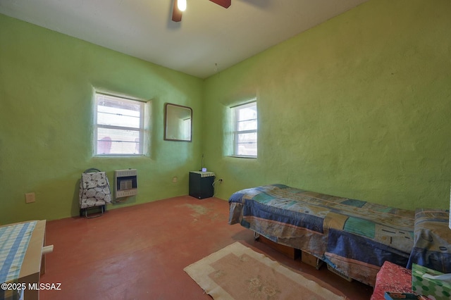 carpeted bedroom featuring ceiling fan and heating unit