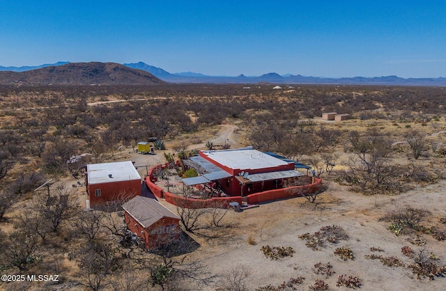 birds eye view of property featuring a rural view, a desert view, and a mountain view