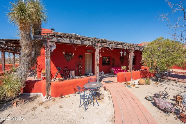 rear view of property featuring a patio area and stucco siding