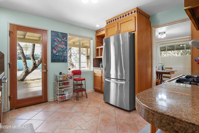 kitchen with freestanding refrigerator, light tile patterned flooring, plenty of natural light, and open shelves