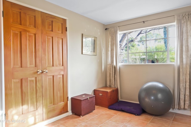 workout room featuring light tile patterned flooring
