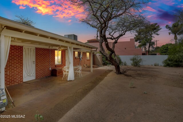 patio terrace at dusk with fence and central AC