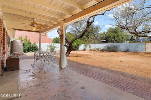 view of patio featuring a fenced backyard, ceiling fan, and outdoor dining space